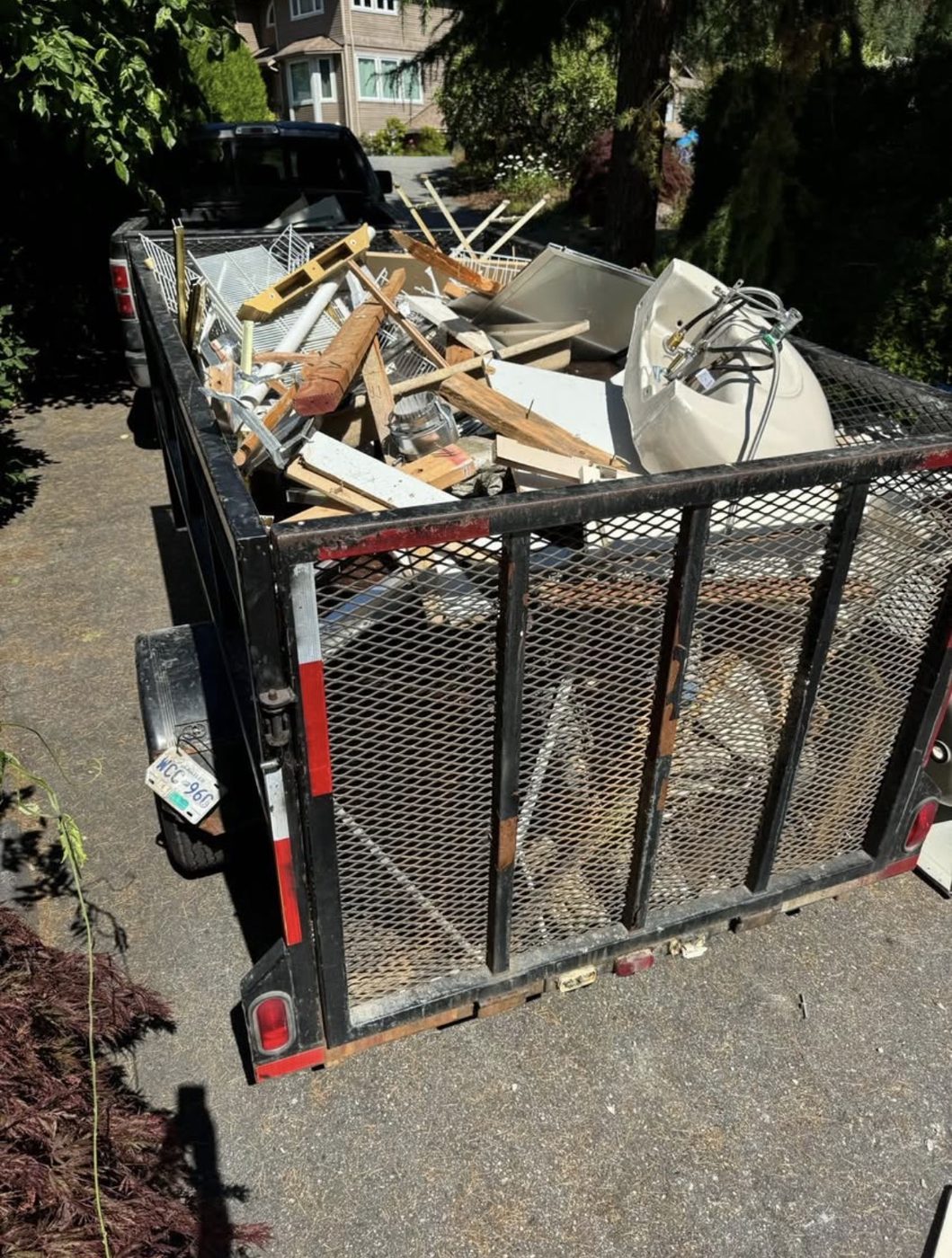 Trailer full of renovation debris, lumber and an old toilet from a Lower Mainland job